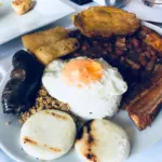 A bandeja paisa, the Colombian platter of beans, rice, fried egg, chicharrón, sausage and arepas